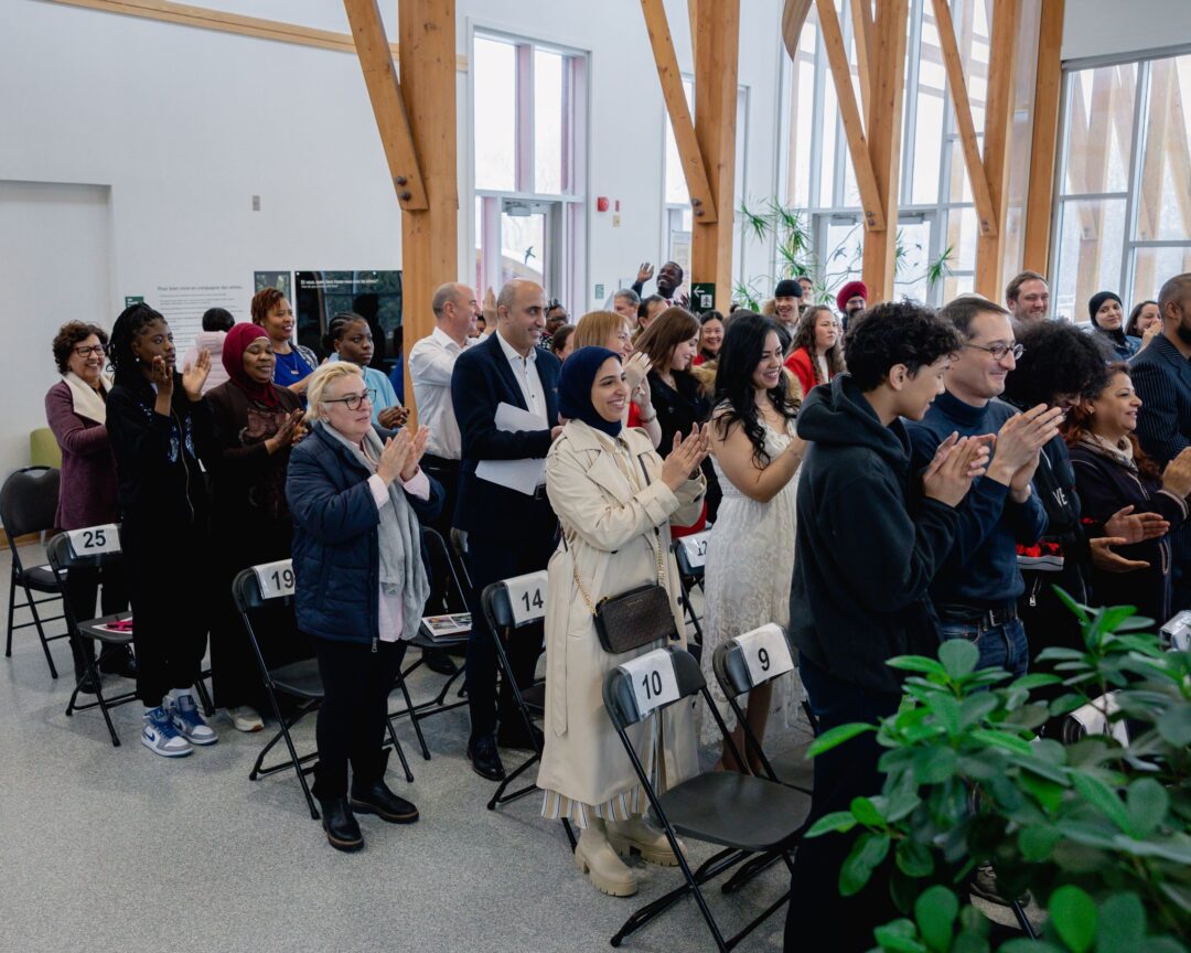Audience clapping at the end of a citizenship ceremony.