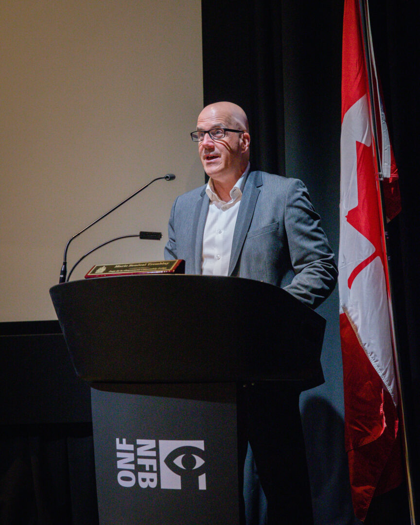 Francois Tremblay congratulating new citizens at Canadian citizenship ceremony.