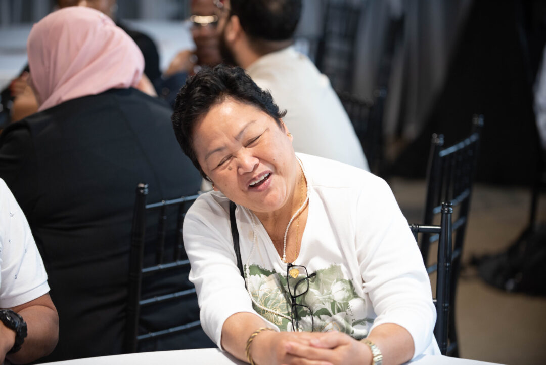 Woman laughing at Canadian citizenship ceremony.