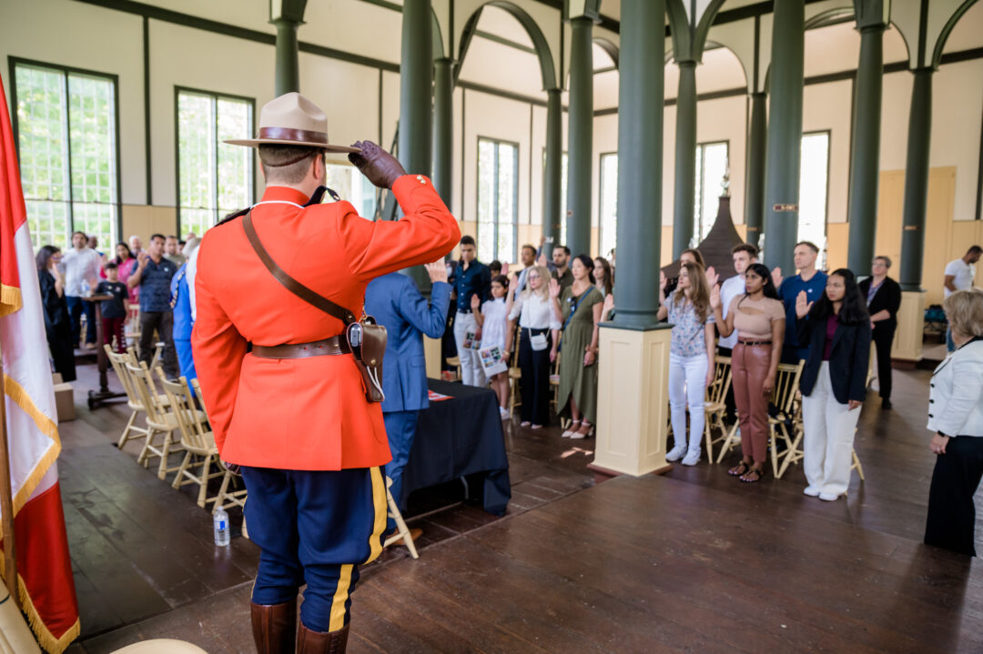People taking the oath of citizenship at a Candian citizenship ceremony in Sharon Temple.