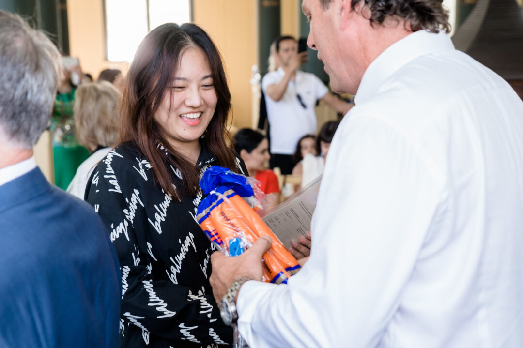 MP Scot Davidson giving a new Canadian citizen a bag of carrots at Sharon Temple.